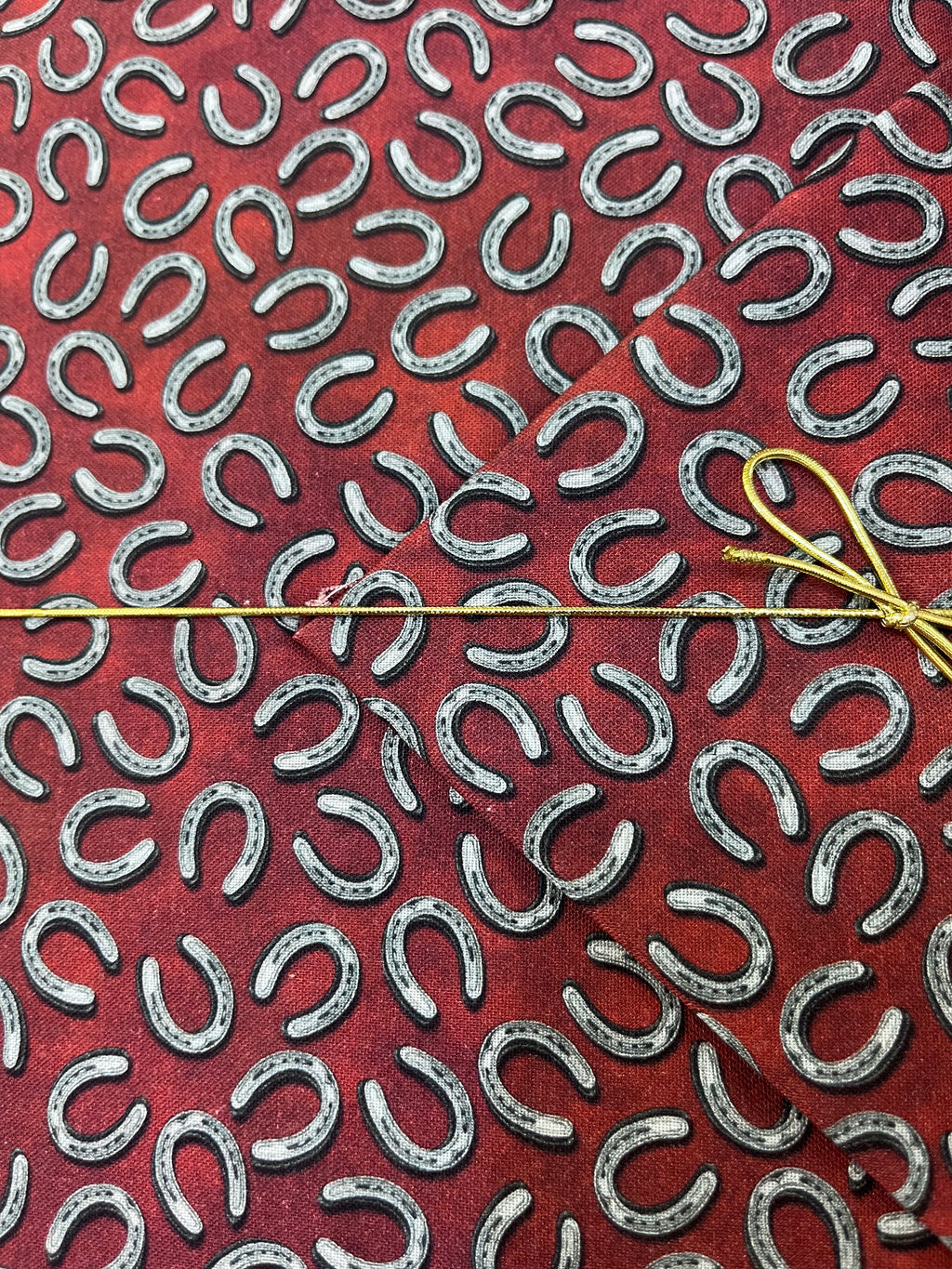 Benartex - Yellowstone - Tossed Horseshoes Brick Red Fabric