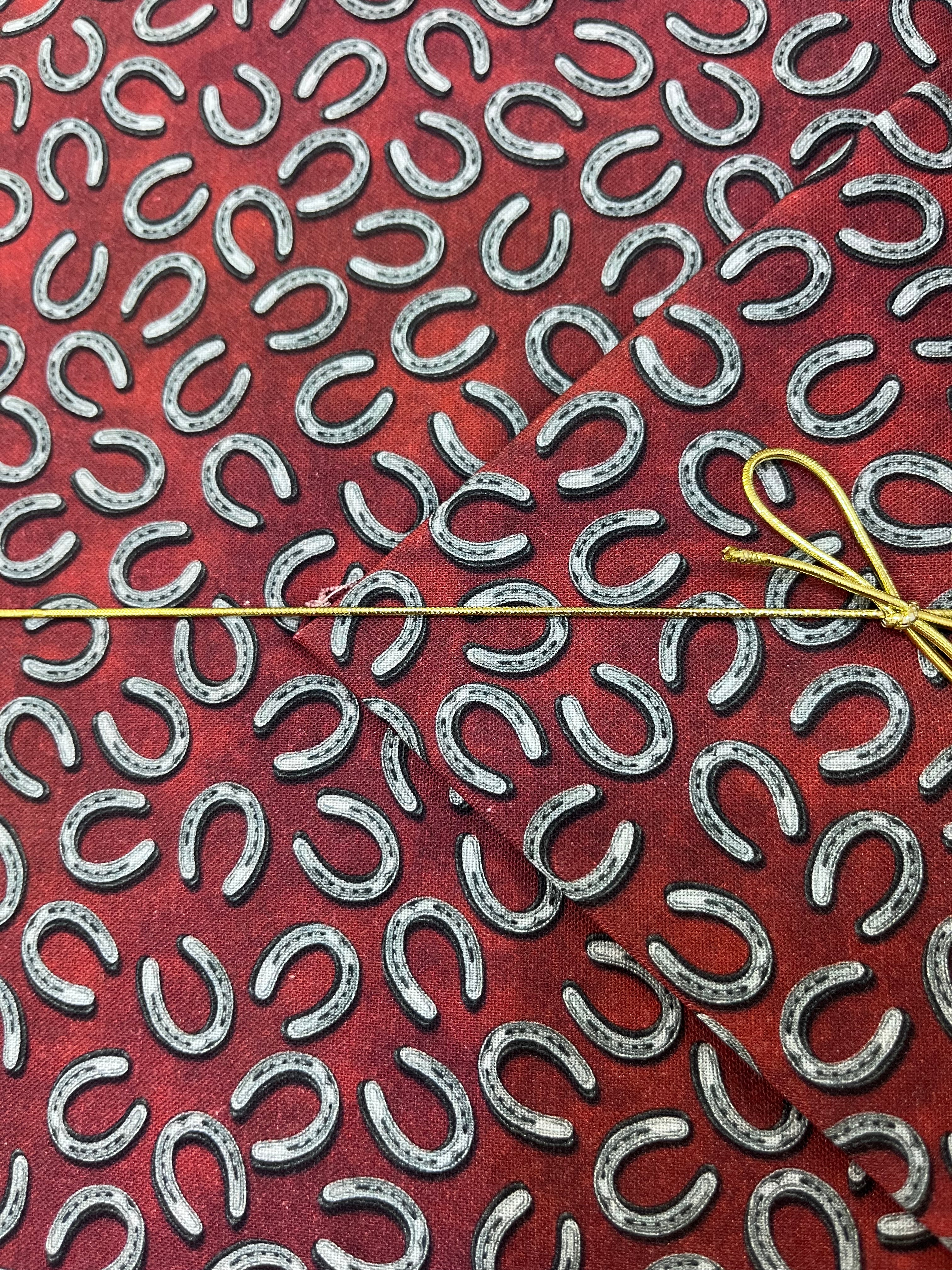 Benartex - Yellowstone - Tossed Horseshoes Brick Red Fabric
